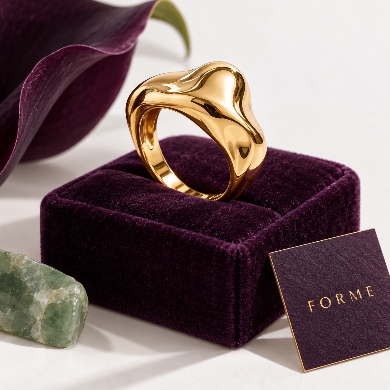 Realistic sculptural gold ring on a purple velvet display